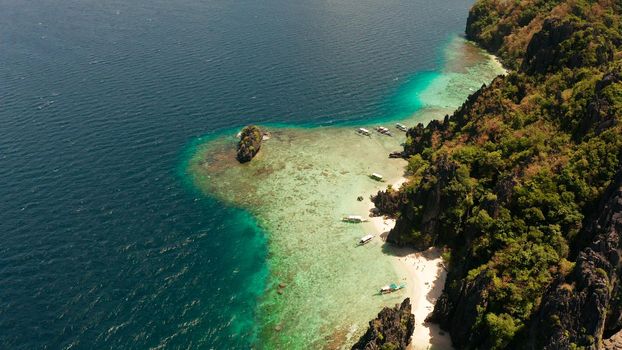 aerial view tropical lagoon with sandy beach surrounded by cliffs. El nido, Philippines, Palawan. beautiful lagoon and karst scenery.