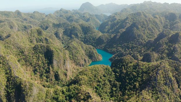 Aerial drone Kayangan lake with blue water on tropical island Coron. Lake in the mountains covered with tropical forest. Palawan, Philippines