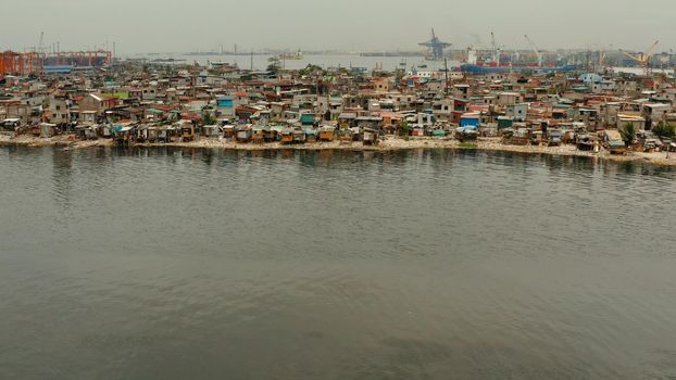 Slum area near port in Manila, Phillippines, top view. lot of garbage in the water.