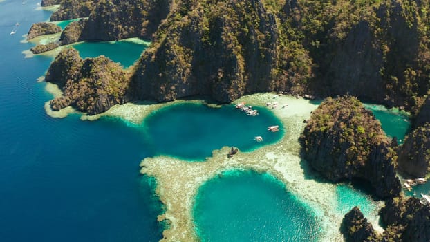 Aerial drone lagoons and coves with blue water among the rocks. lagoon, mountains covered with forests. Seascape, tropical landscape. Palawan, Philippines, Busuanga