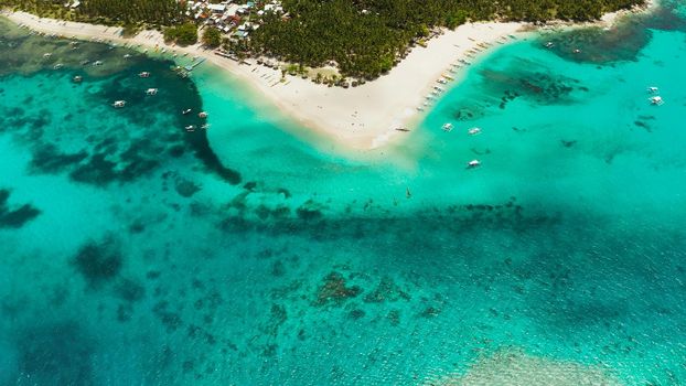 Tropical landscape: Daco island with beautiful beach, palm trees by turquoise water view from above. Siargao, Philippines. Summer and travel vacation concept
