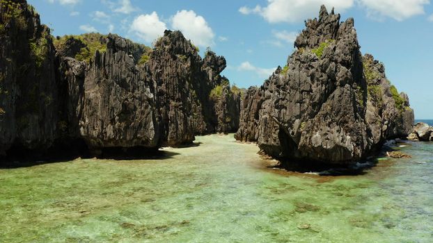 aerial view of tropical lagoon with sandy beach surrounded by cliffs. El nido, Philippines, Palawan. beautiful lagoon and karst scenery.