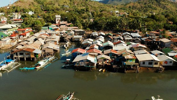 Coron city with slums and poor district. Old wooden house standing on the sea in the fishing village. Houses of local poor people.Busuanga, Coron, Philippines. houses community standing in water in fishing village.