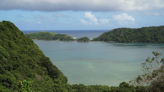 Seascape tropical island, lagoon, beach and hills.. Tropical landscape sky, clouds and mountains rocks with rainforest. Blue lagoon in the ocean. Travel concept.