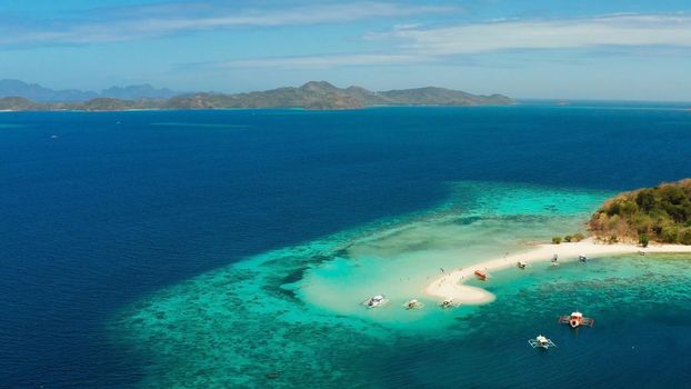 aerial seascape tropical island with sand bar, turquoise water and coral reef. Ditaytayan, Palawan, Philippines. tourist boats on tropical beach. Travel tropical concept. Palawan, Philippines