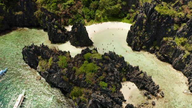 Tropical lagoon with sandy beach surrounded by cliffs. El nido, Philippines, Palawan. beautiful lagoon and karst scenery.