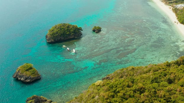 Tropical sandy beach near the blue lagoon and corall reef, aerial view Boracay, Philippines. Ilig Iligan Beach. Summer and travel vacation concept.