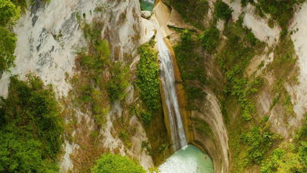 Beautiful waterfall in green forest, top view. Tropical Dao Falls in mountain jungle, Philippines, Cebu. Waterfall in the tropical forest.