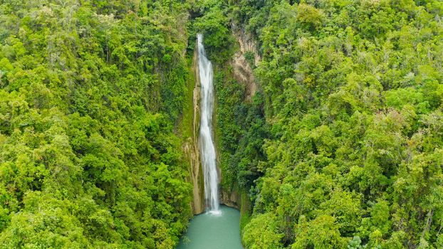 Beautiful waterfall in green forest, top view. Tropical Mantayupan Falls in mountain jungle, Philippines, Cebu. Waterfall in the tropical forest.