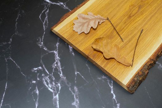 oak leaves on an oak Board on black marble. High quality photo