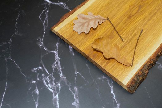 oak leaves on an oak Board on black marble. High quality photo