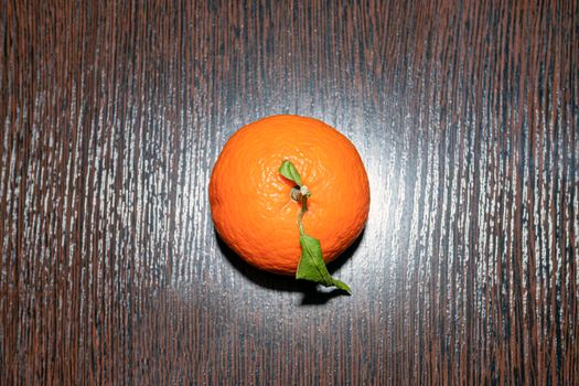 tangerine with leaves on a wooden table top view. High quality photo