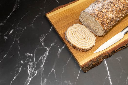 pastry roll on a wooden Board on black marble. High quality photo