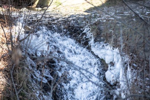 wild river in winter with spray