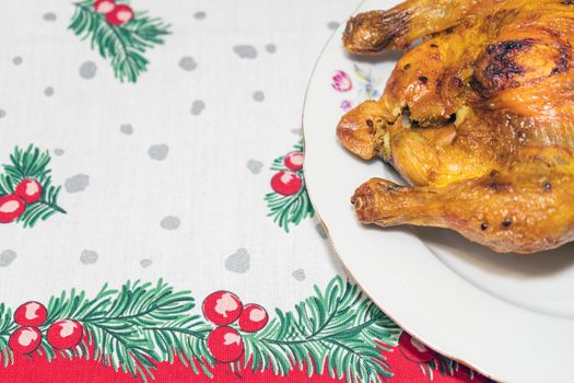 a plate of fried chicken on a New Year's tablecloth. High quality photo