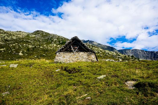 Alp Corte di Mezzo in front of mountain range in the Alps, Ticino, Switzerland