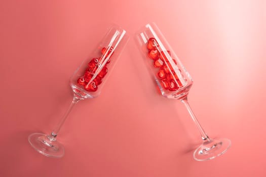 two glasses with hearts on a red background. the view from the top. High quality photo