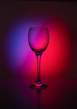silhouette of transparent glass on red and purple background