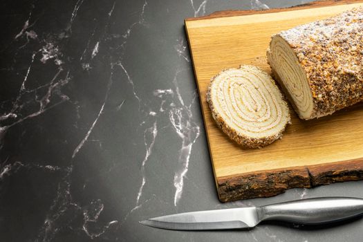 pastry roll on a wooden Board on black marble. High quality photo