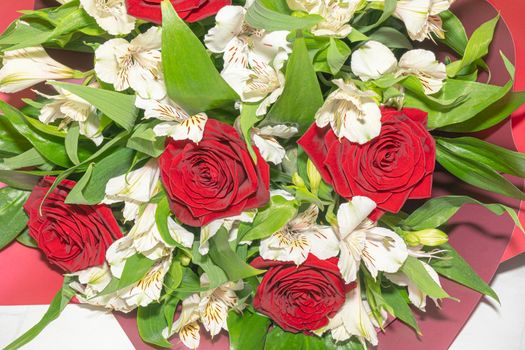 bouquet of red roses and white alstroemeria flowers close up. High quality photo