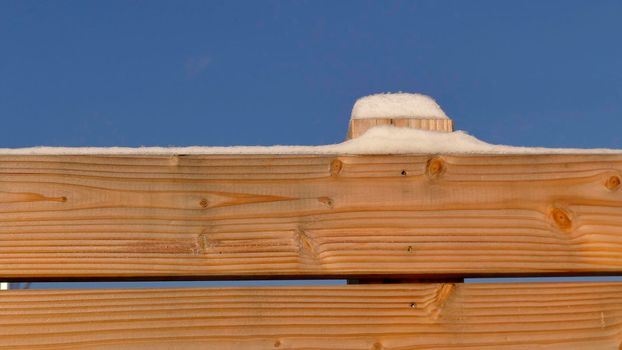 snow hat on a wooden fence