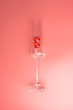 wine glass with two hearts on a pink background. High quality photo