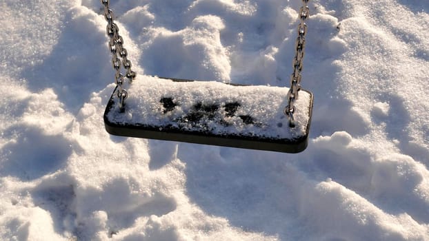 swing with snow cover in wintertime