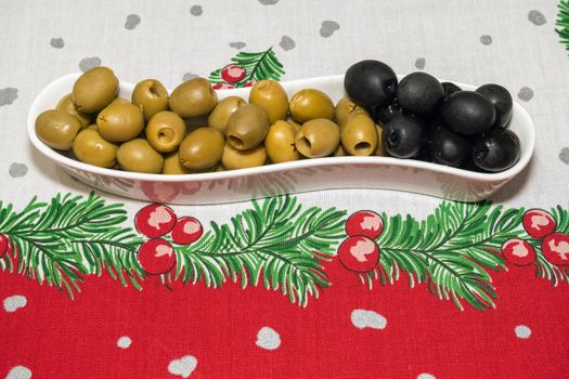 a plate of olives on a New Year's tablecloth. High quality photo