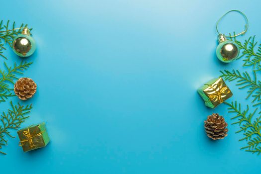 new year's card. toys and branches of thuja on a blue background. High quality photo