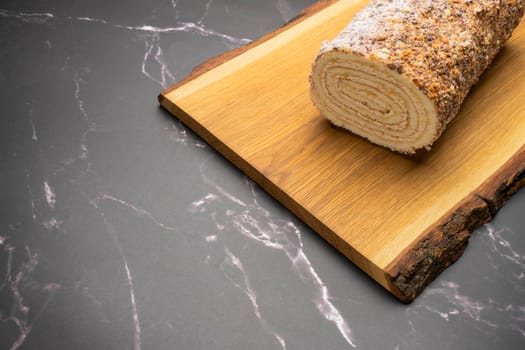 pastry roll on a wooden Board on black marble. High quality photo
