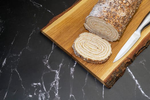 pastry roll on a wooden Board on black marble. High quality photo
