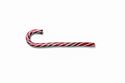caramel Christmas cane close up on a white background. High quality photo