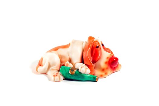 dog figurine with bottle on white background