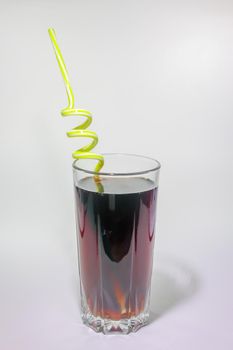 a glass of soft drink with a pipe on a light background. High quality photo