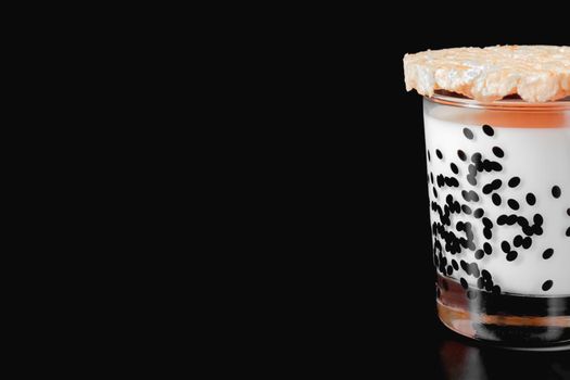 a glass of milk and cornbread on a black background. health food. isolate. High quality photo