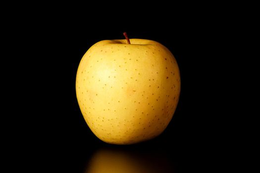 yellow Apple on a black background close-up.isolate. High quality photo