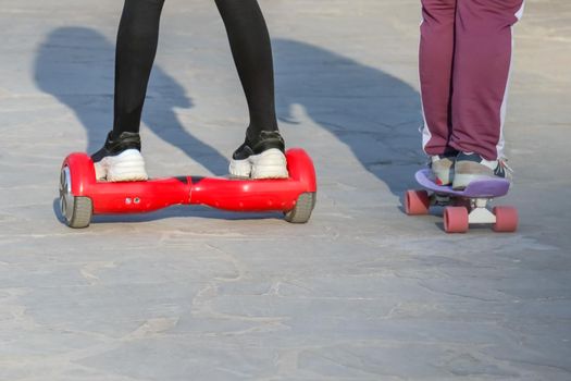 Teens riding gyrometer and skateboard closeup. High quality photo