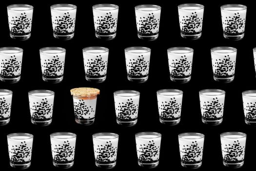 colorful pattern of a glass of milk on a black background top view. High quality photo