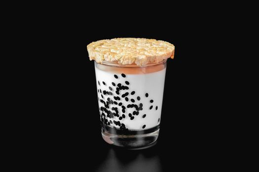 a glass of milk and cornbread on a black background. health food. isolate. High quality photo