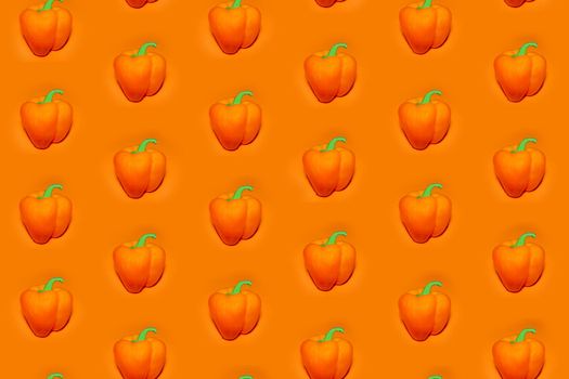 colorful vegetable pattern of orange bell pepper on an orange background. the pattern of bell pepper. the view from the top. High quality photo