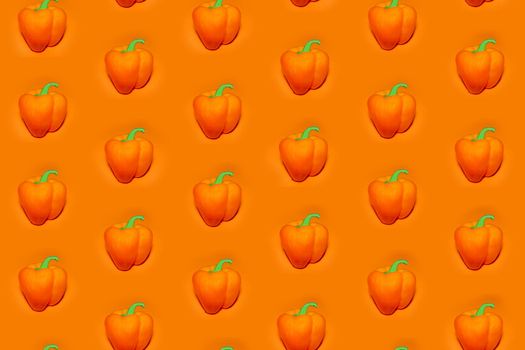 colorful vegetable pattern of orange bell pepper on an orange background. the pattern of bell pepper. the view from the top. High quality photo