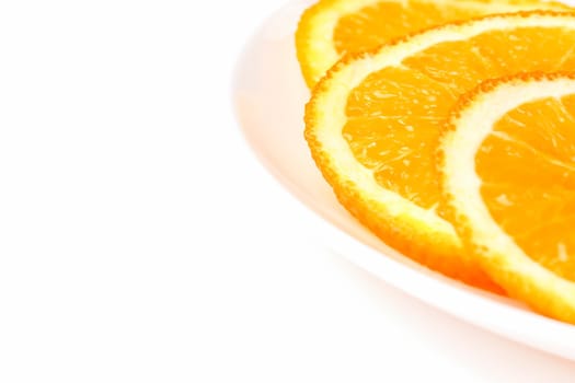 orange slices on a white plate on a white background. High quality photo