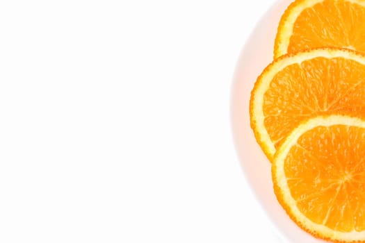 orange slices on a white plate on a white background. High quality photo