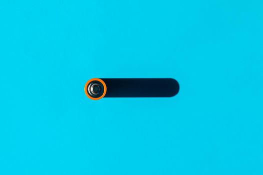 battery with a hard shadow on a plain background. the view from the top. blank for the pattern. High quality photo