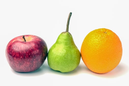 orange and green pear and red Apple close up on a white background. High quality photo