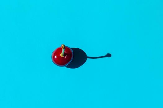 cherry berry with a hard shadow on a plain background. the view from the top. blank for the pattern. High quality photo