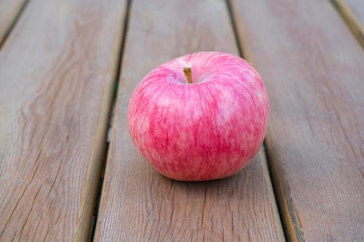 red Apple on a wooden table close-up. High quality photo