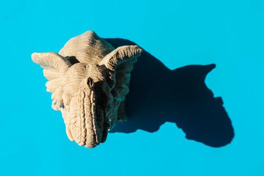 elephant statuette with a hard shadow on a plain background. the view from the top. blank for the pattern. High quality photo