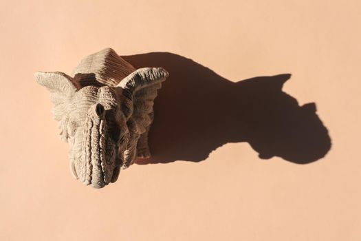 elephant statuette with a hard shadow on a plain background. the view from the top. blank for the pattern. High quality photo