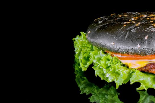 black hamburger close up on a black background . High quality photo